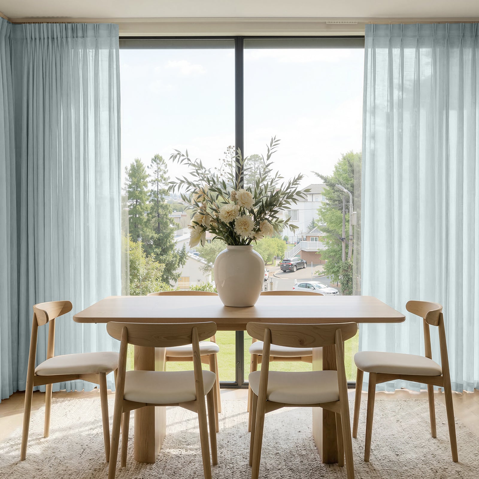 Willow lightweight light blue sheer custom curtains, filtering sunlight with a linen blend fabric for a light, airy ambiance.
