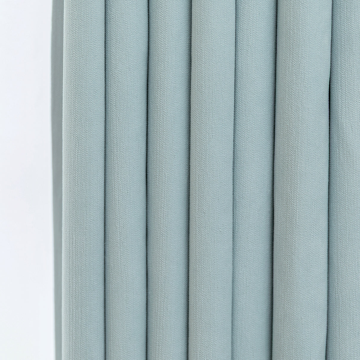 Pale blue chenille fabric texture with vertical pleats for custom blackout curtains