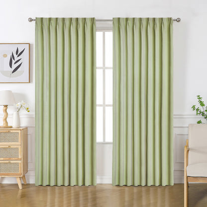 Light green velourette chenille blackout curtains with solid pattern and grommet top, shown in a room setting.