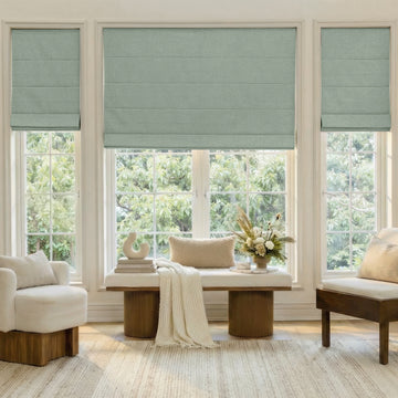 Custom sage green faux linen blackout Roman shades.