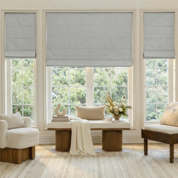 Alder Faux Linen blackout Roman shades in light grey, custom fit window treatments.