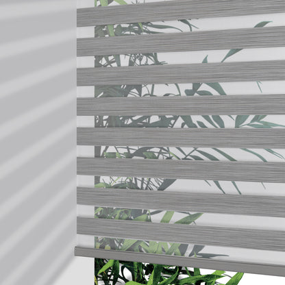 Joydeco Pro cordless zebra blinds in grey stripe pattern with leaf motif, partially lowered to show light filtering effect.