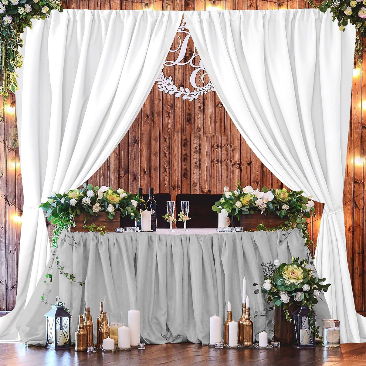 White polyester backdrop curtains draped elegantly for wedding reception. Ideal for parties and photography backdrops.