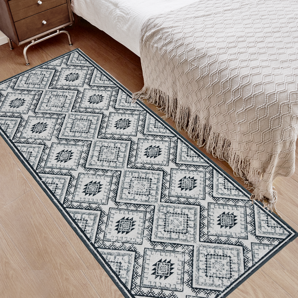 Grey and white vintage geometric runner rug on wooden floor next to bed in bedroom, machine washable.