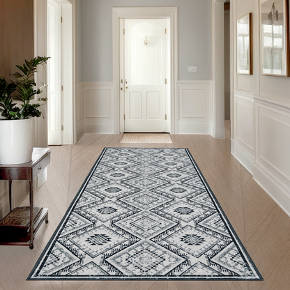 Joydeco grey and white vintage geometric runner rug in a hallway with light wood floors and a console table.