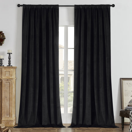 Joydeco black velvet blackout curtains 84 inch two panels hang in a rustic living room.