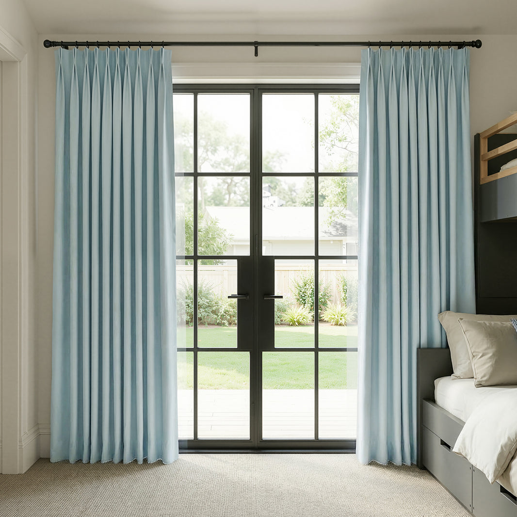 Custom light blue chenille blackout curtains with pinch pleats.