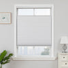 White cordless blackout honeycomb shades with top-down bottom-up feature in a window.