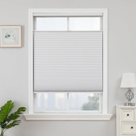 White cordless blackout honeycomb shades with top-down bottom-up feature in a window.