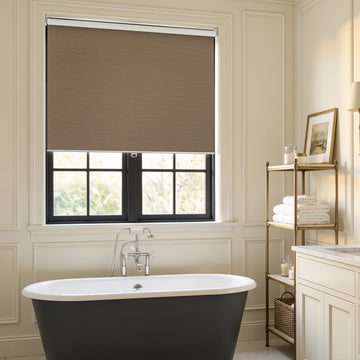 Custom Ashby taupe plain weave blackout roller shade for window treatments.