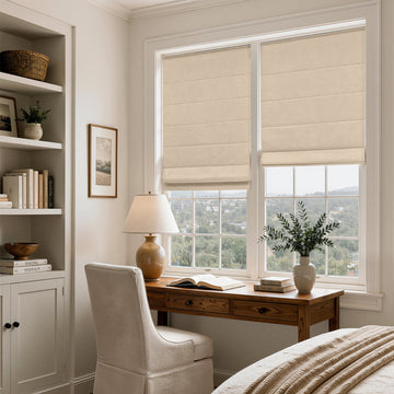 Beige linen blend blackout Roman shades on twin windows in a calm bedroom office