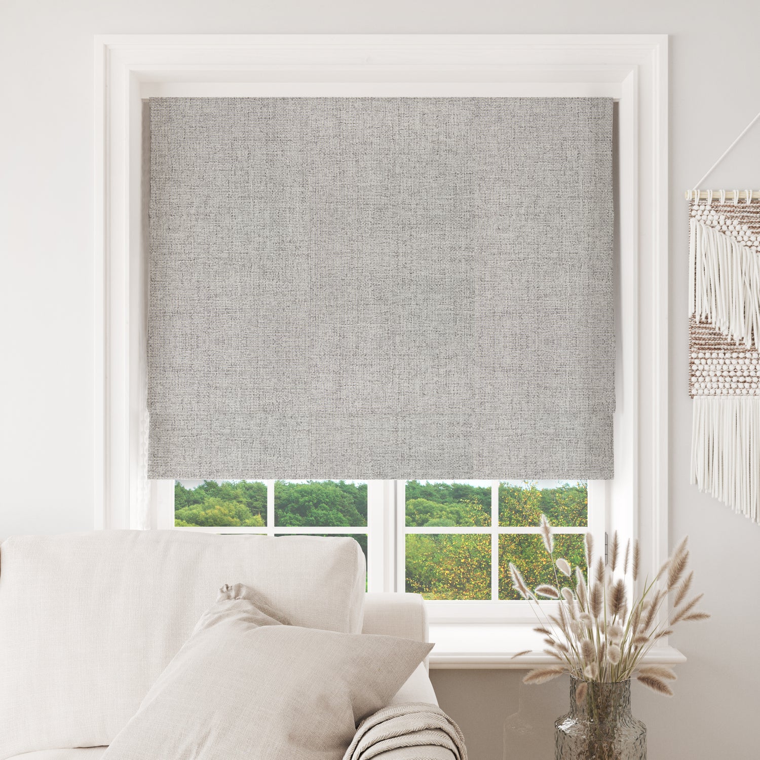 Joydeco light grey blackout Roman shade installed in window with sofa, offering room light control.