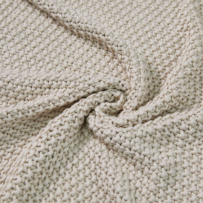 Light beige 100% cotton chunky knit throw blanket showing detailed texture, perfect for rustic farmhouse decor.
