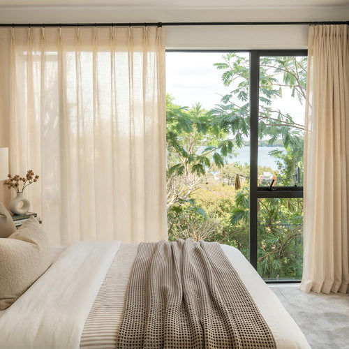 Sustainable custom Linden Linen Blend sheer curtains, soft beige, scenic view.