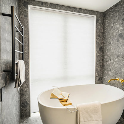 Solace Light Filtering Cellular Shade in white, softly filtering light for bathroom privacy.