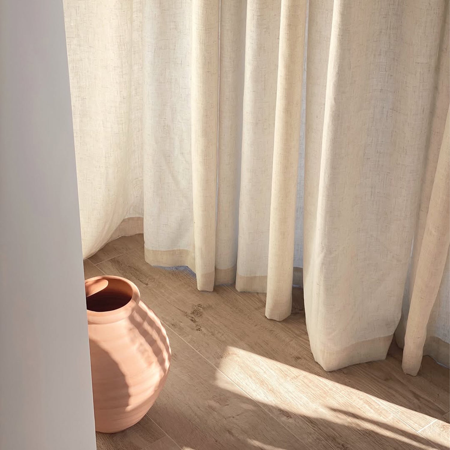 Joydeco off-white semi-sheer linen blend curtains with natural texture filtering sunlight onto wooden floor.
