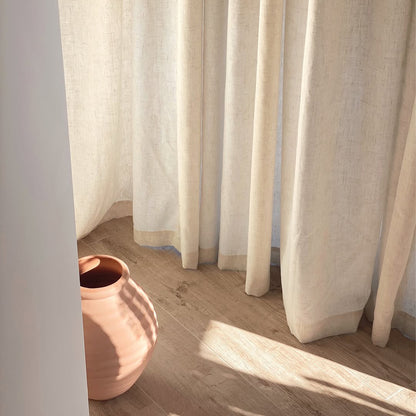 Joydeco off-white semi-sheer linen blend curtains with natural texture filtering sunlight onto wooden floor.