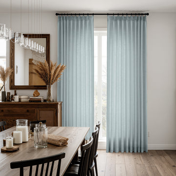 Light blue textured linen blend curtains in a dining room, soft light-filtering drape
