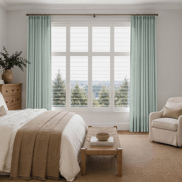 Mint green custom linen look curtains framing a bright bedroom window