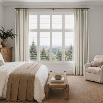 Cream linen-look custom curtains framing a bright bedroom window