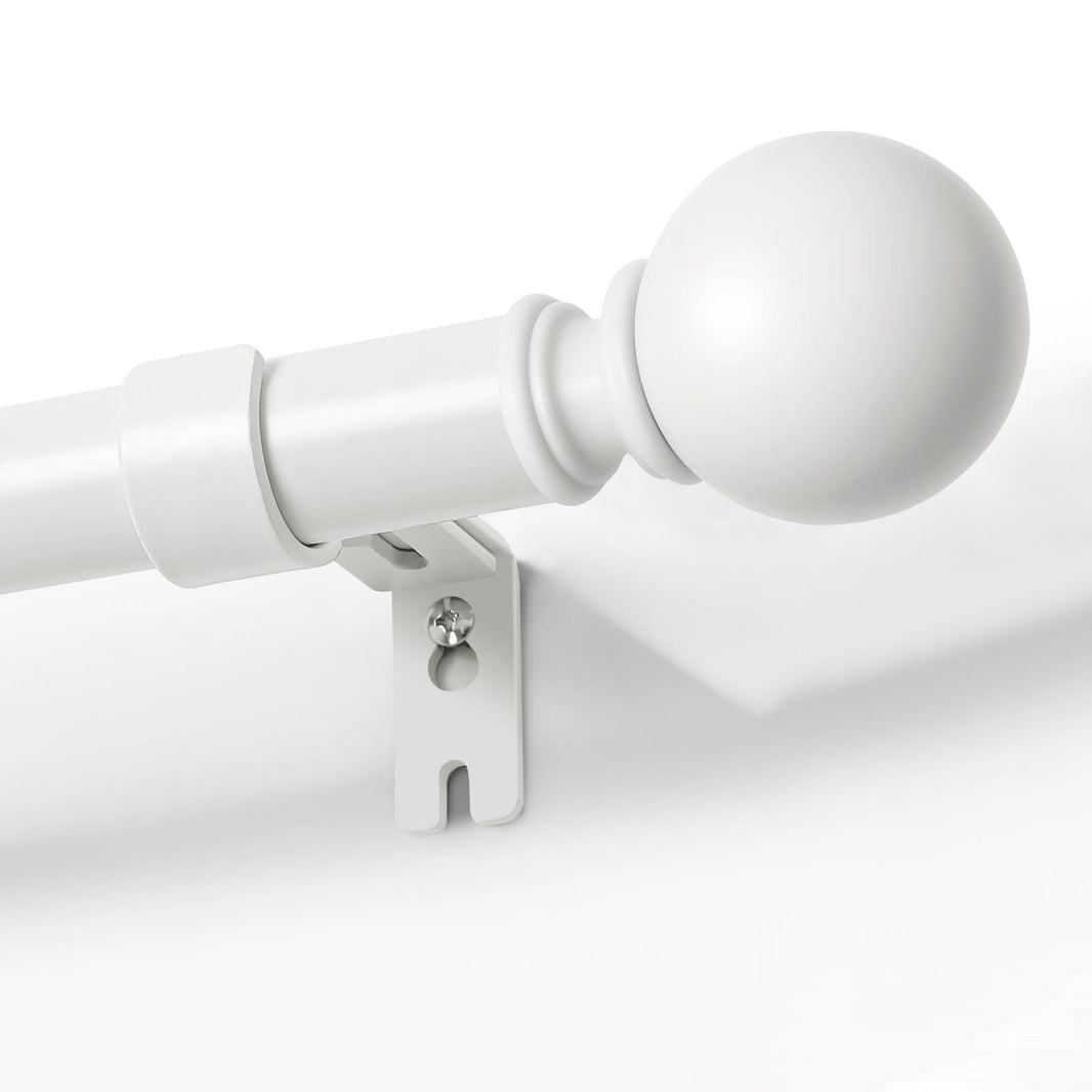Joydeco matte black adjustable curtain rod, 1-inch diameter, with spherical finial and bracket, mounted on white wall.