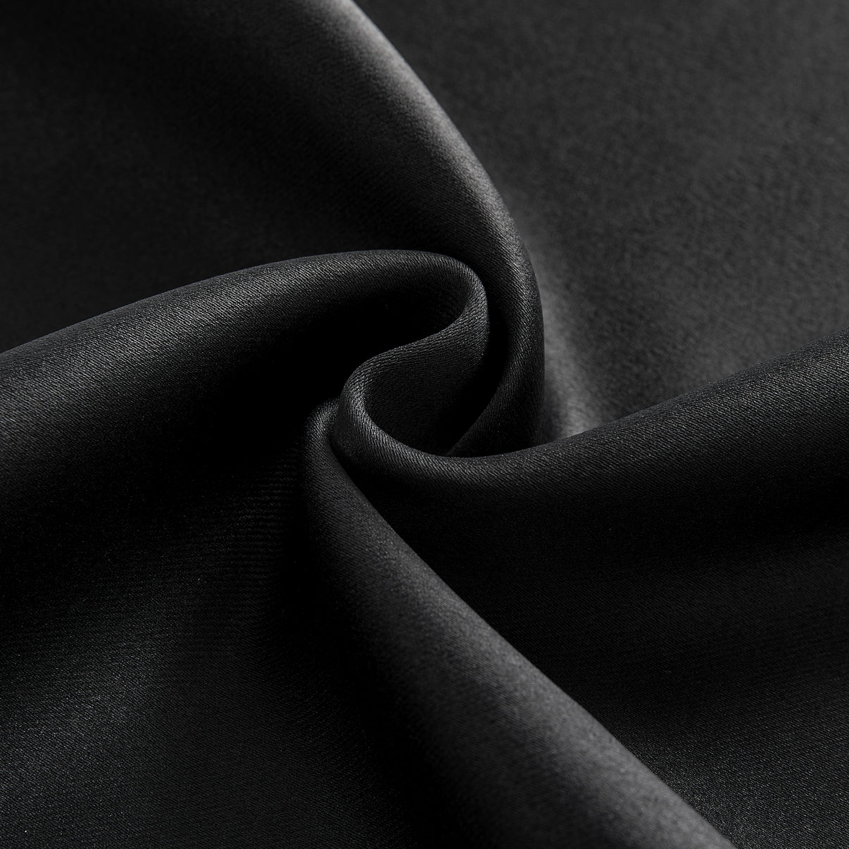 Close-up black blackout curtain fabric texture, dense polyester weave, matte finish, soft folds for room darkening.