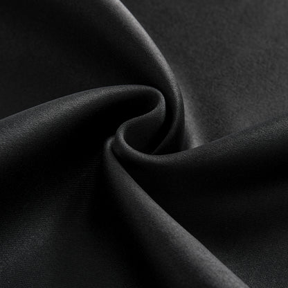 Close-up black blackout curtain fabric texture, dense polyester weave, matte finish, soft folds for room darkening.