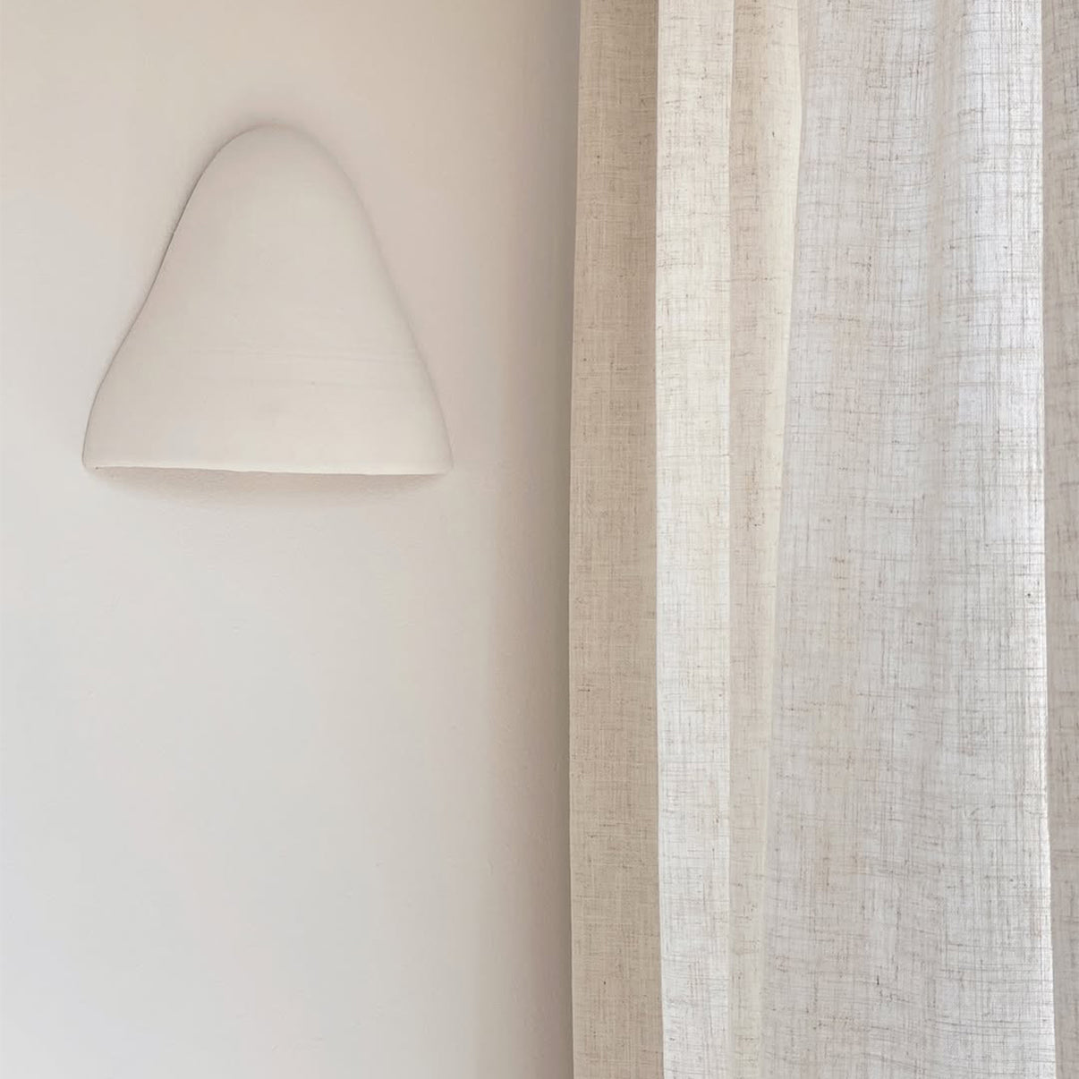 Joydeco pale cream linen blend semi-sheer curtain with visible texture, filtering light in a living room.
