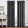 Two charcoal grey Joydeco blackout curtains 95 inch with grommets hang from a silver rod in a bedroom.
