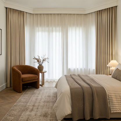 Beige chenille blackout curtains with sheer curtains in a bedroom.