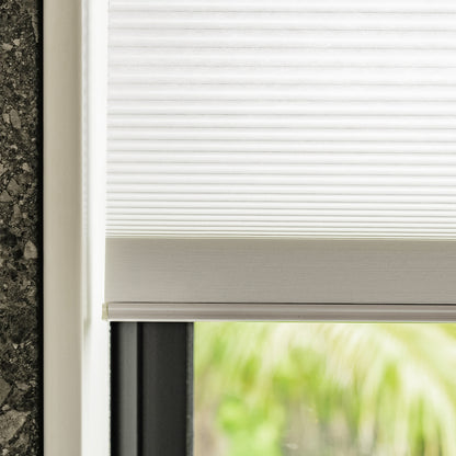 White Solace cellular shade, honeycomb texture, light filtering blinds and shades.
