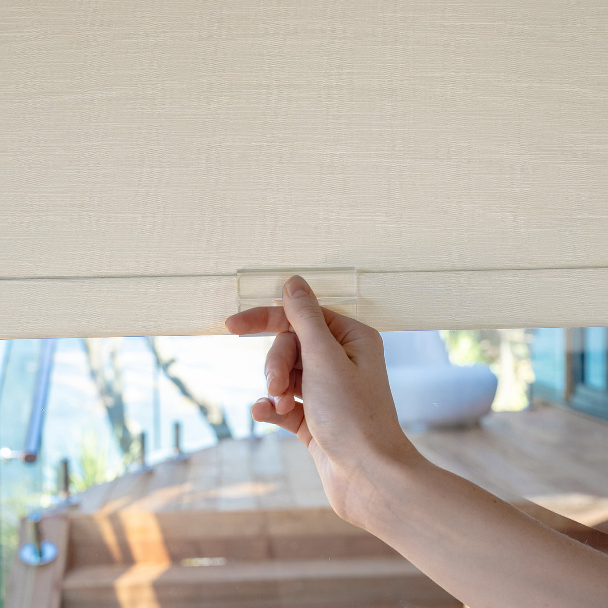 Hand demonstrating Ashby's easy no-drill blackout roller shade installation.