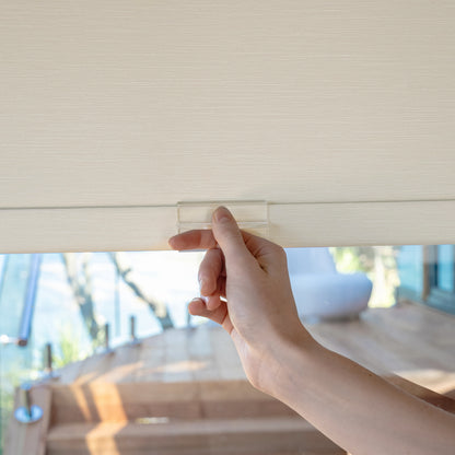 Hand demonstrating Ashby's easy no-drill blackout roller shade installation.