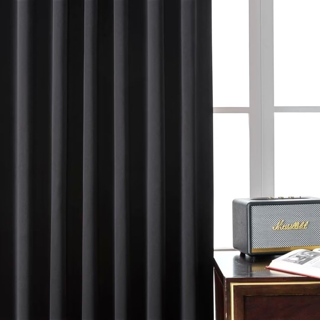 Black polyester blackout curtain, 72 inches long, with pleats, shown on a window with a rod pocket and back tab header.