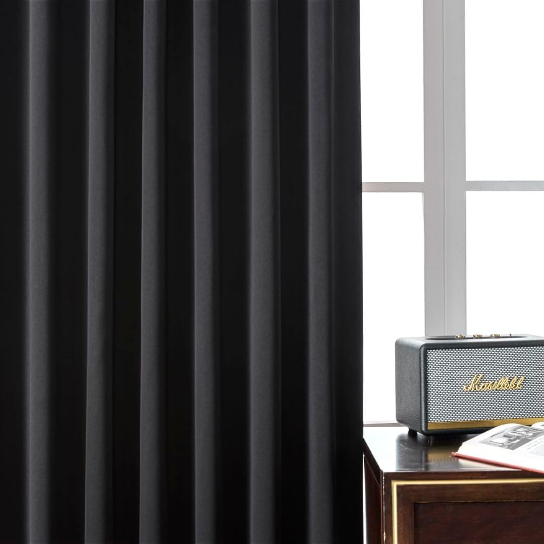 Joydeco black 90 inch thermal insulated blackout curtains, matte texture, in a living room.