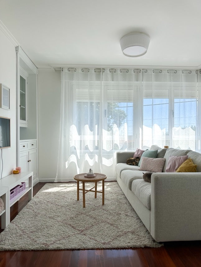 Joydeco white sheer curtains with rod pocket design in a bright living room, filtering sunlight onto a beige sofa with cats.