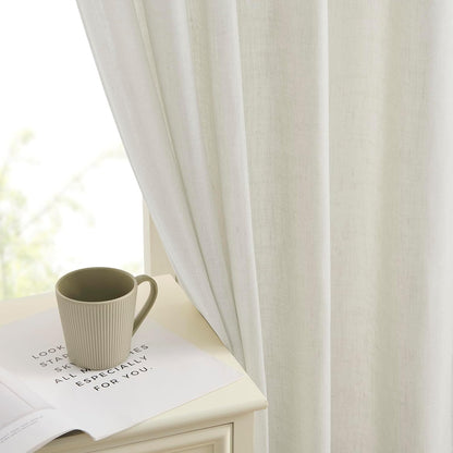 Joydeco natural linen blend curtain texture with light filtering effect, shown with mug on book near window.