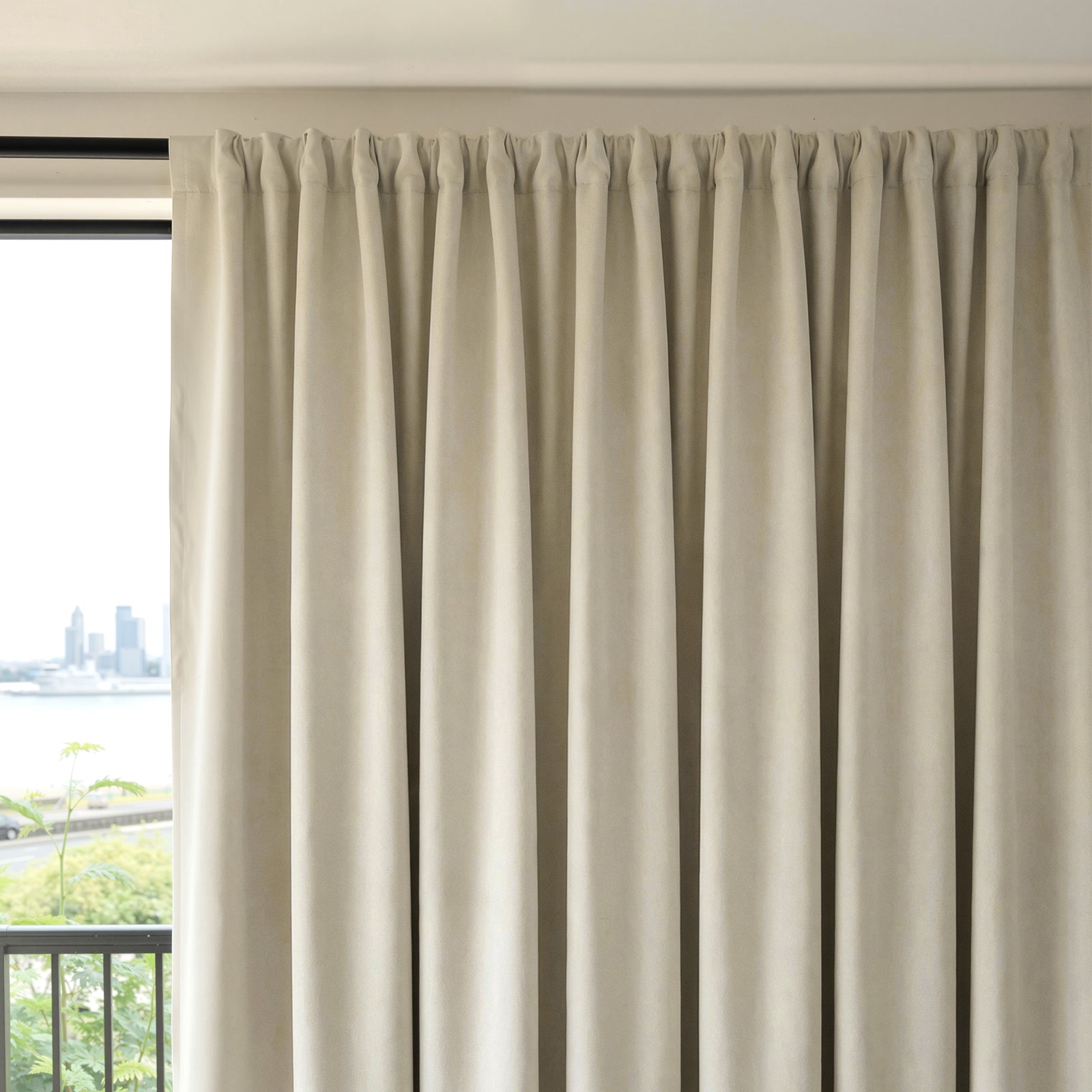 Beige Everly heavyweight chenille room darkening curtain, pleated top, offering light blocking.