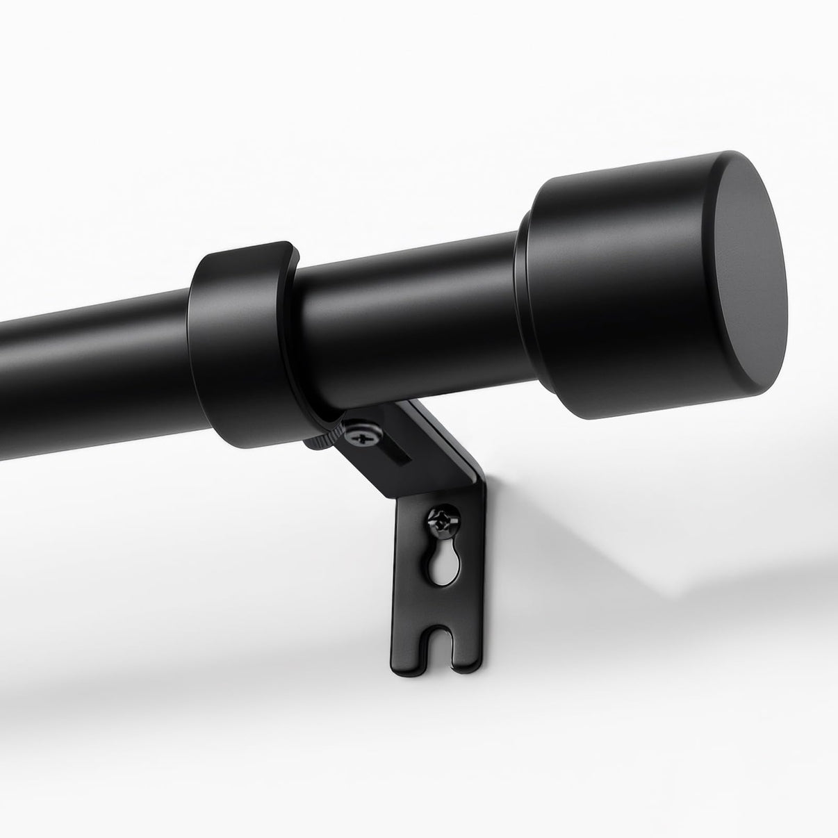Joydeco modern black adjustable curtain rod, 1 inch diameter, with sleek finial and heavy-duty bracket shown mounted on wall.
