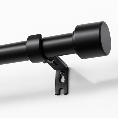 Joydeco modern black adjustable curtain rod, 1 inch diameter, with sleek finial and heavy-duty bracket shown mounted on wall.