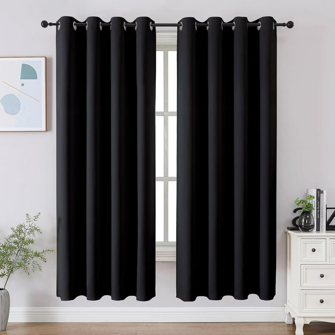 Two black Joydeco blackout curtains with grommet tops shown in a room setting, 72 inch length.