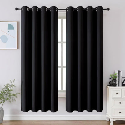 Two black Joydeco blackout curtains with grommet tops shown in a room setting, 72 inch length.