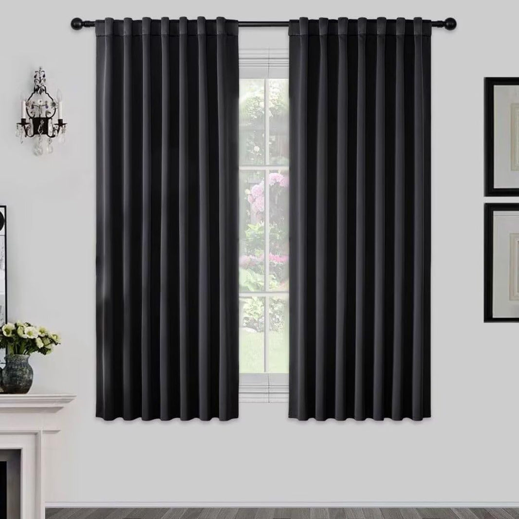 Black polyester blackout curtains 72 inch long, room darkening drapes with rod pocket and back tab design on a window.