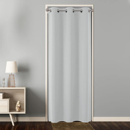 Light grey grommet blackout curtain used as a room divider on a doorway, floor-length, modern design.