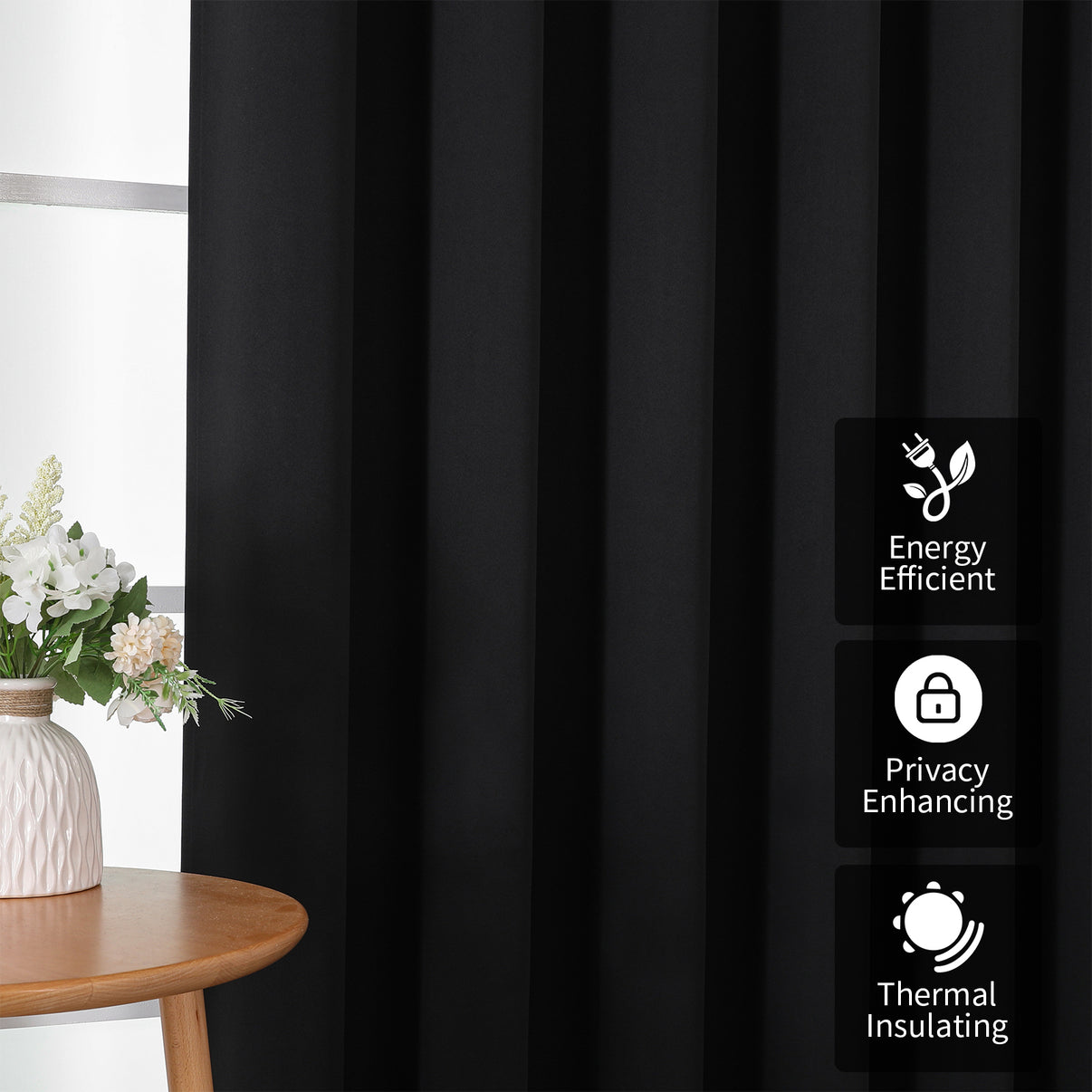 Close-up of black extra-wide blackout curtain with pleats, highlighting energy efficiency, privacy, and thermal insulation.