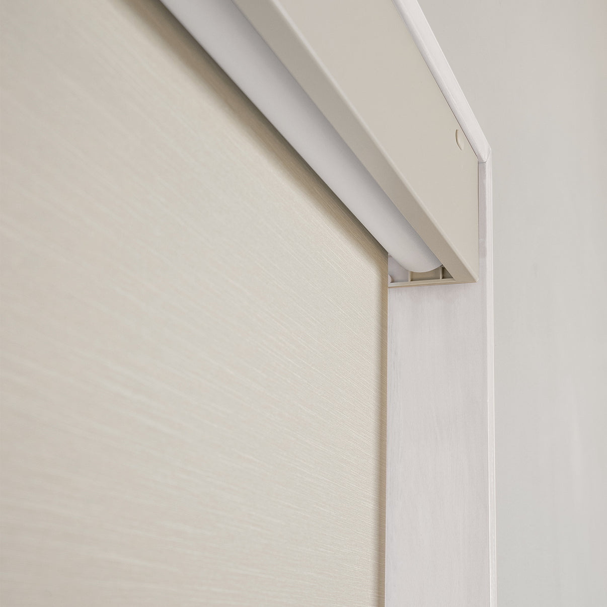 Minimalist light beige plain weave fabric of Ashby No-Drill Blackout Roller Shade.