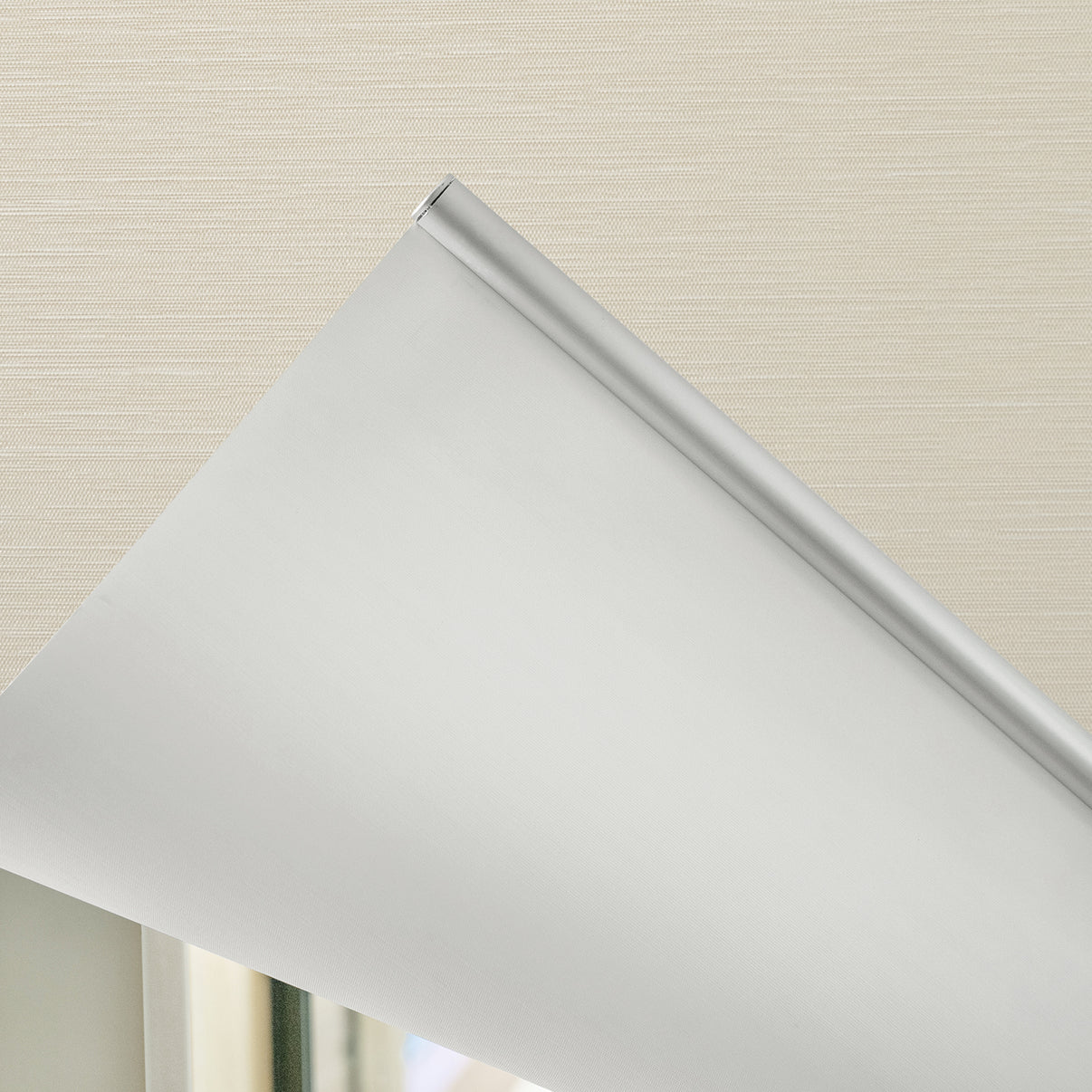 Ashby light grey blackout roller shade with silver hardware, plain weave fabric.