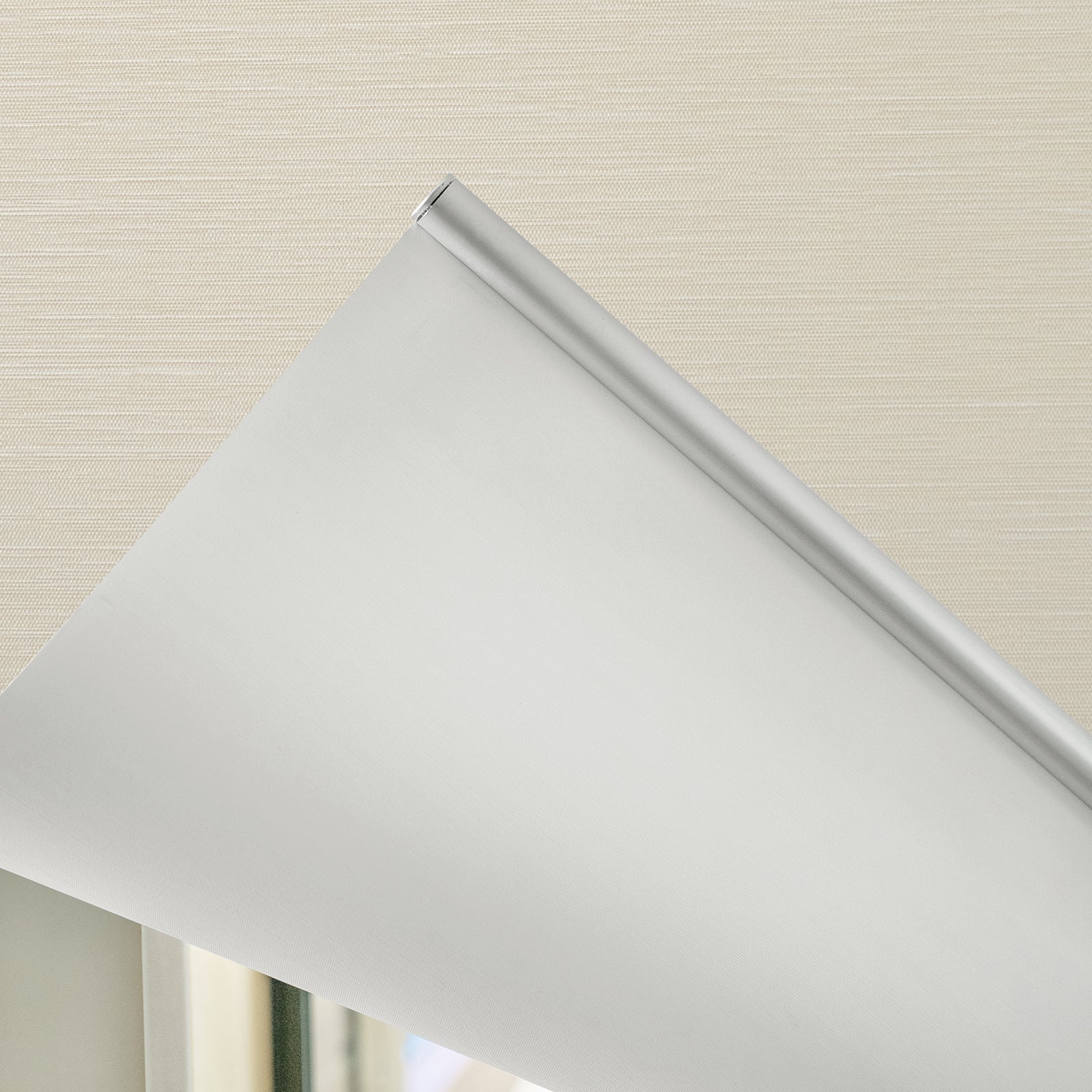 Ashby light grey blackout roller shade with silver hardware, plain weave fabric.
