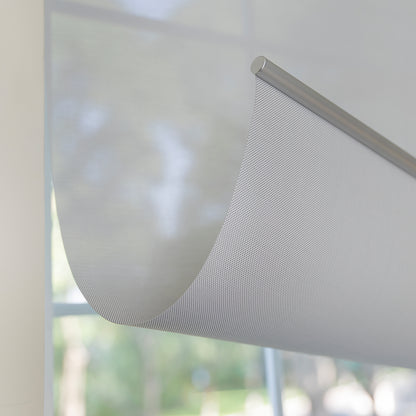 Joydeco Cove light filtering solar shade with semi-sheer grid fabric.