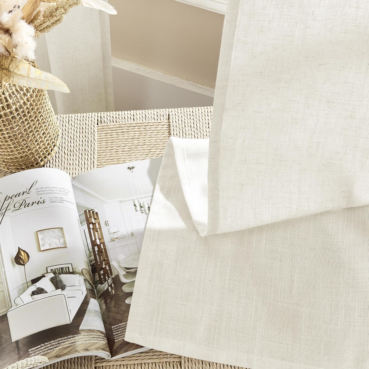 Joydeco ivory linen-blend sheer curtain fabric texture, displayed with interior design magazine and vase.